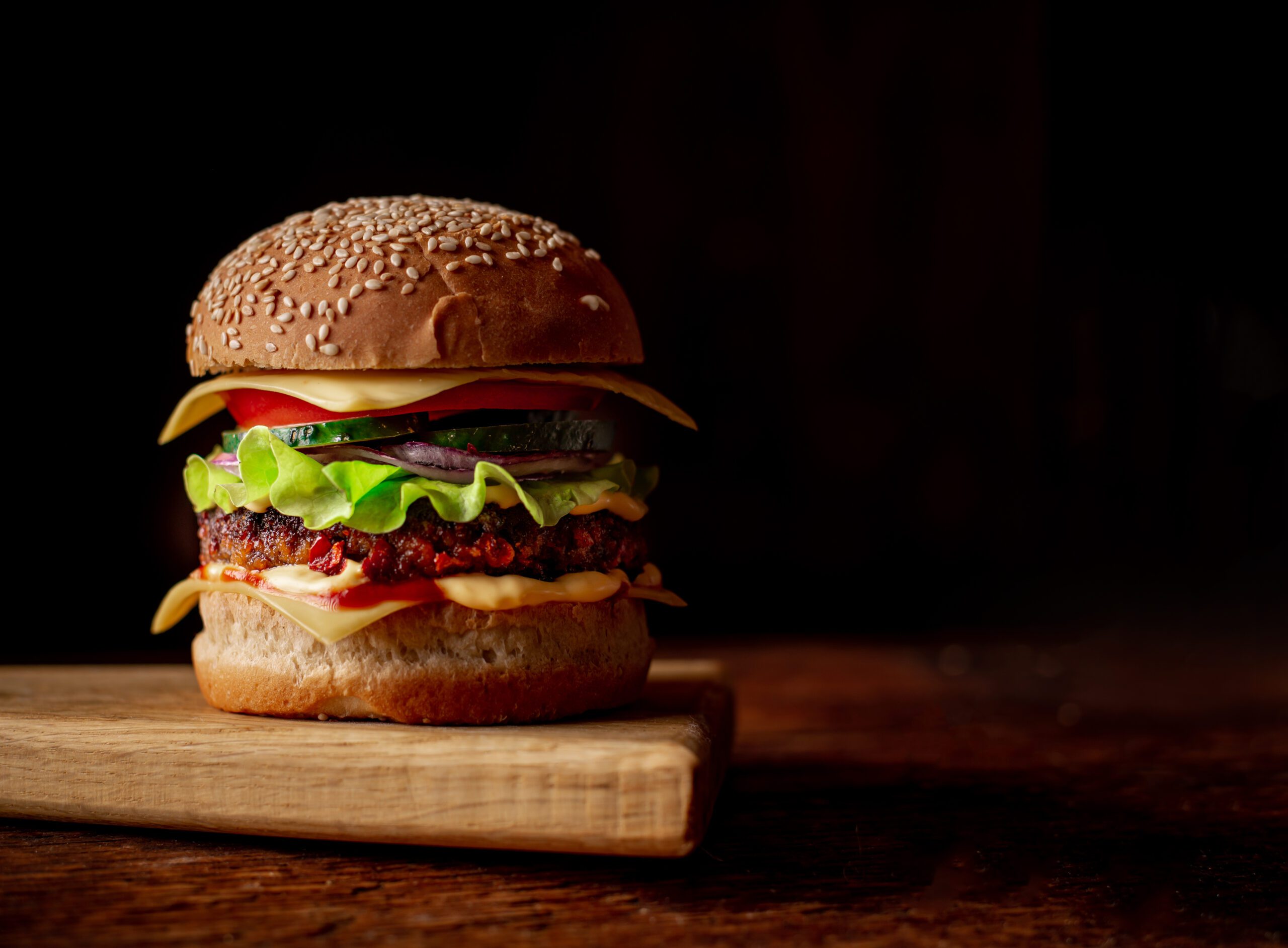 cheeseburger on a wooden cutting board