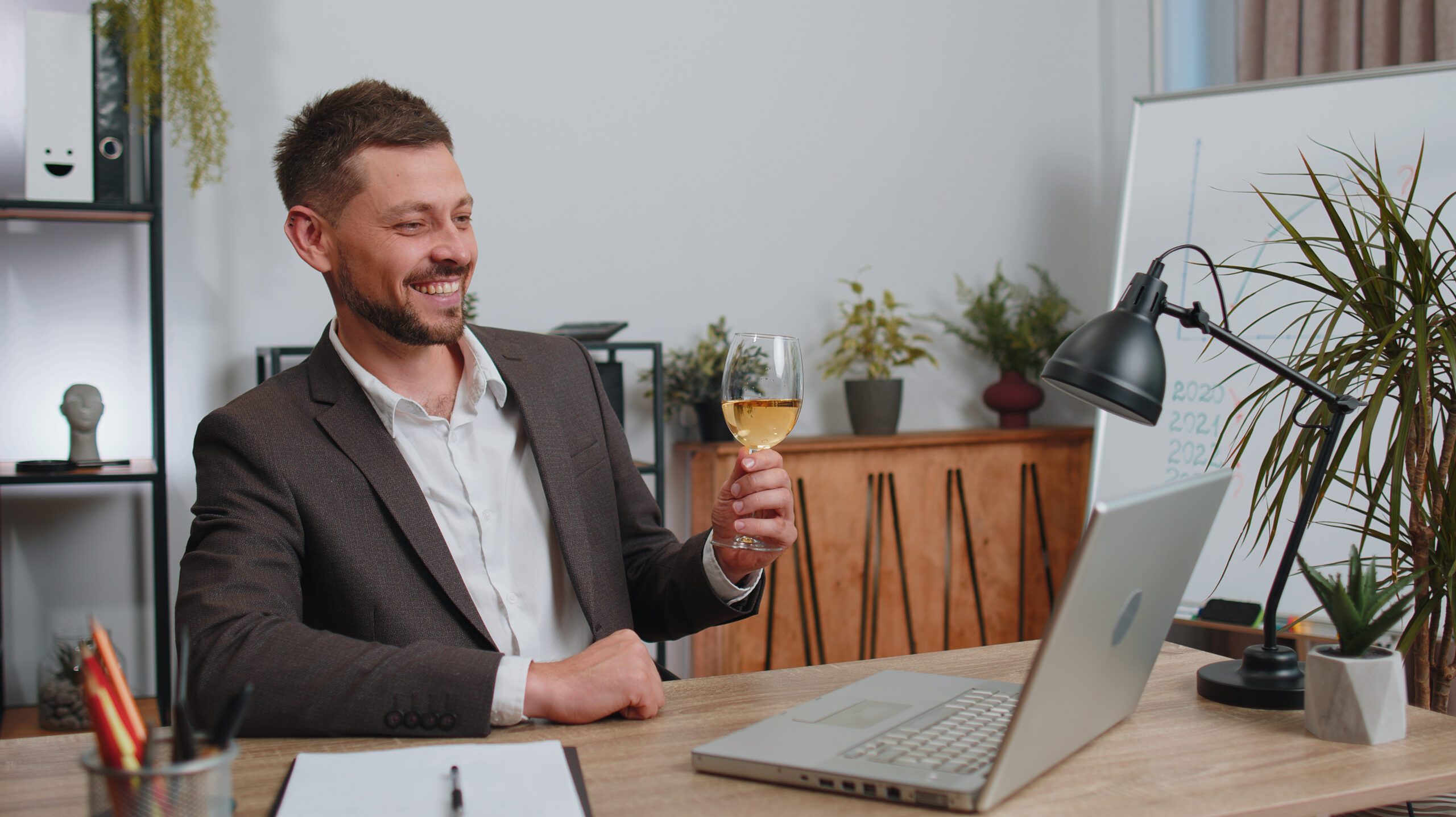 a teacher drinking in front of a laptop for back to school